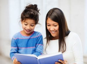 Family, children, education, school and happy people concept - mother and daughter with book